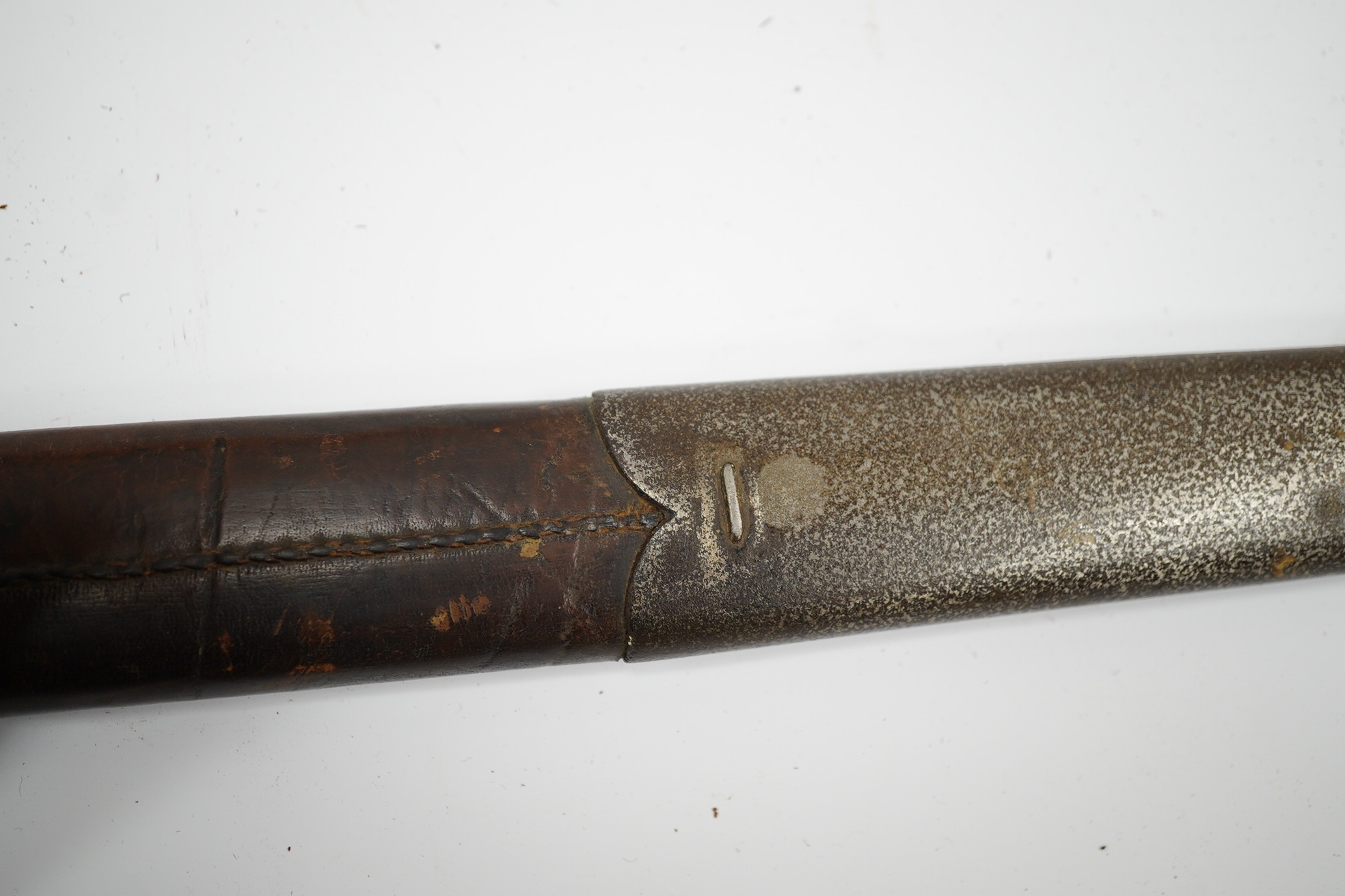 A mid-19th century British infantry sword, by Mole, Birmingham, marked I.S.D., in its leather scabbard with iron chape. Condition - poor, surface rust and knuckle guard significantly cut down.